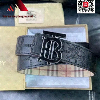 A checked canvas belt with a dark monogram buckle, lying on its box and tissue paper next to a printed card.